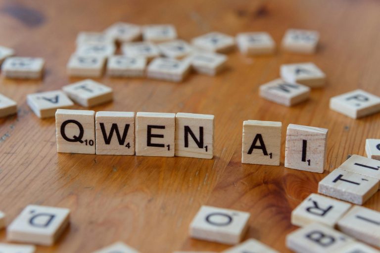 Scrabble-like tiles arranged to spell 'Qwen AI' on a wooden surface, depicting technology concepts.